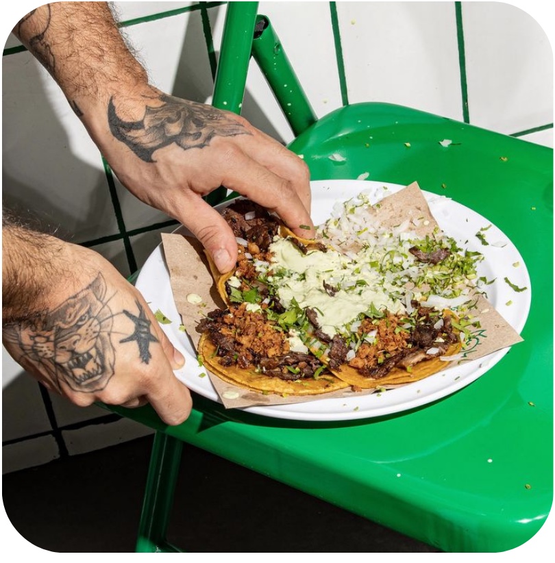 Tacos being served on a plate at a restaurant